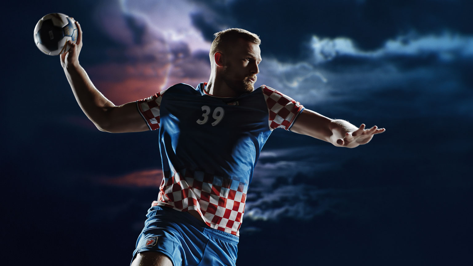 croatian handball player Mandic throwing on a stormy background
